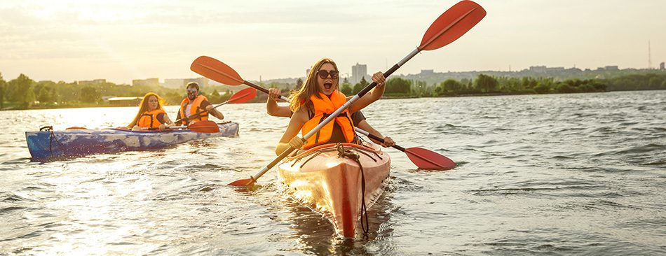 People paddling in canoes having fun